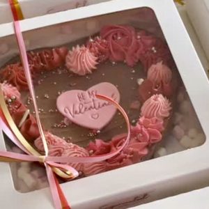 Valentines Brownie with chocolate ganache topping and pink and red decorations in a beautifully presented gift box